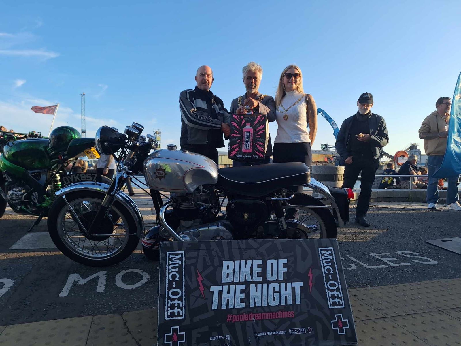 Bike night winner with his motorbike and the judge. 